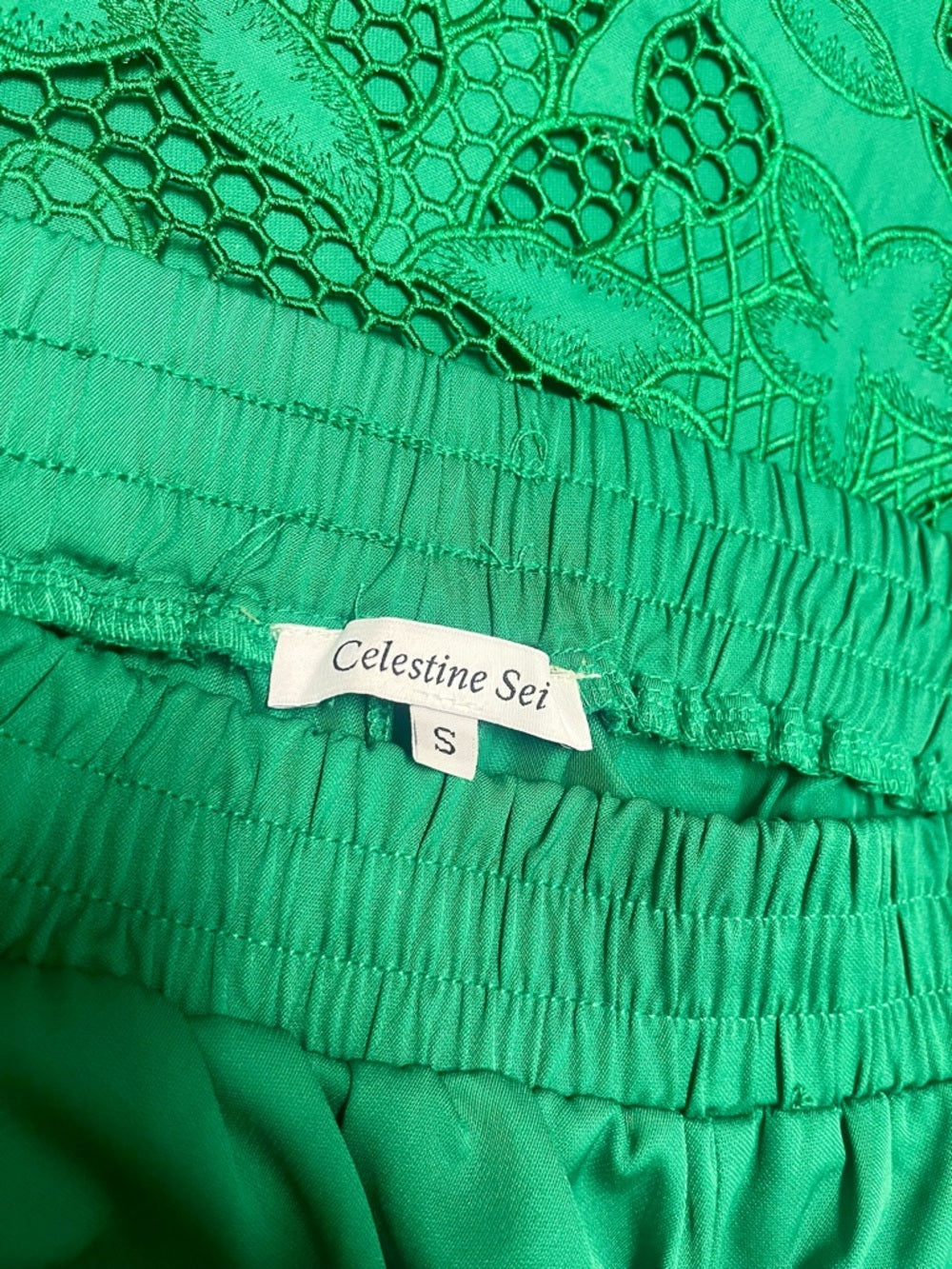Smocked-Waist Wide Leg Pants in Emerald Green with Embroidered Hem — fabric texture and material closeup